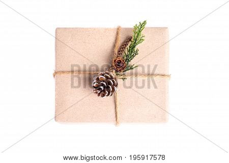 Brown Paper Craft Warped On Present Box Decorate With Pine Cone And Green Leaf Isolated On White Bac