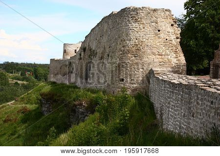 Wall and part of a tower of a fortress in Izborsk. All is made of limestone.