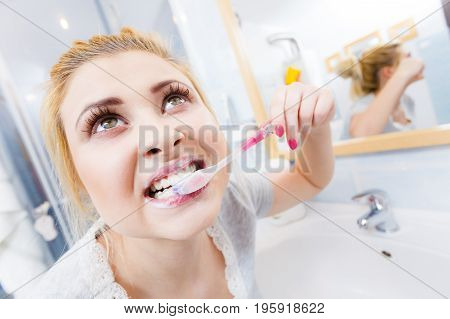 Woman Brushing Cleaning Teeth In Bathroom