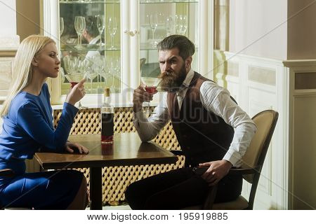 Woman And Man Drinking From Martini Glasses