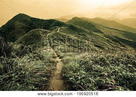 Storybook landscape of a footpath through rolling hills on the Caoling Historic Trail in Taiwan