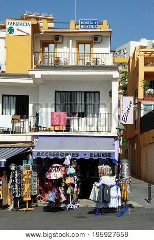 TORREMOLINOS, SPAIN - SEPTEMBER 3, 2008 - Shop selling tourist goods below a hostal along the promenade Torremolinos Malaga Province Andalusia Spain Western Europe, September 3, 2008.