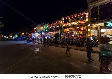 Hoi An, Vietnam - August 14, 2015: restaurants and shops on the banks of the Thu Bon river on Nguyen Phuc Chu in Hoi An at night.