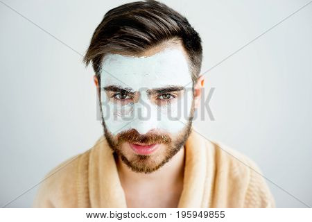 A portrait of a man with a clay mask