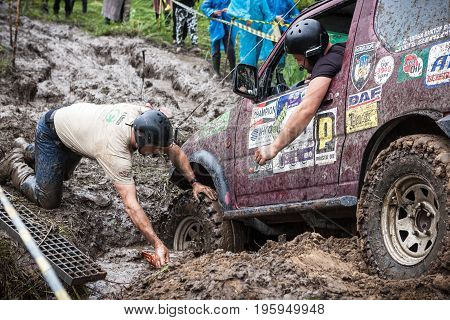 LUBOTIN UKRAINE - JULY 23 2016: RFC Ukraine Wild Boar Challenge 2016. Team using recovery sand tracks to overcome a hard pit.