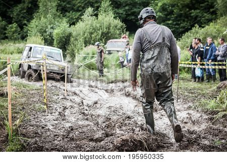 LUBOTIN UKRAINE - JULY 23 2016: RFC Ukraine Wild Boar Challenge 2016. One of the participants of the race walking through the deep mud.