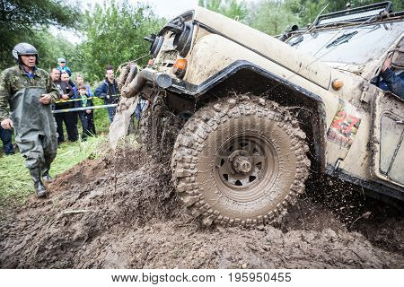 LUBOTIN UKRAINE - JULY 23 2016: RFC Ukraine Wild Boar Challenge 2016. Uaz 469 overcomes a muddy pit.