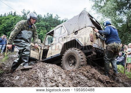 LUBOTIN UKRAINE - JULY 23 2016: RFC Ukraine Wild Boar Challenge 2016. Uaz 469 overcomes a muddy pit.