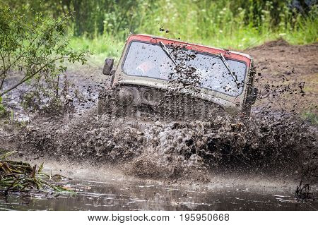 LUBOTIN UKRAINE - JULY 23 2016: RFC Ukraine Wild Boar Challenge 2016. Custom built Off-road Trophy UAZ 469 in the swamp at high speed.