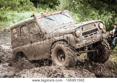 LUBOTIN UKRAINE - JULY 23 2016: RFC Ukraine Wild Boar Challenge 2016. Custom built Off-road Trophy UAZ 469 passing mud pit.