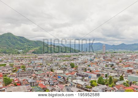 KAMINOYAMA JAPAN - MAY 28 2017: View of Sankichiyama Mount and Kaminoyama City from donjon of Kaminoyama Castle. Sky Tower 41 skyscraper is in the right corner
