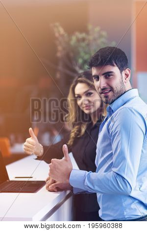 Young couple working together on a laptop in the office. Teamwork concepts