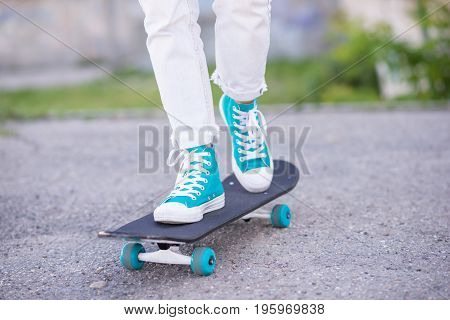 Beautiful girl rides on a highway on Longboard scenic street. Solar toning. Close-up portrait. Healthy lifestyle.
