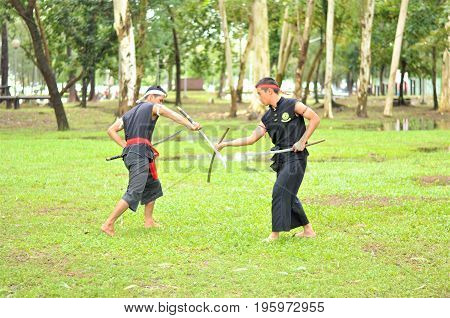 PUKED,THAILAND - AUGUST 28: Master trick of ancient fighter on August 28, 2011 in Puked Thailand.
 Master show how to trick of fight with swords.