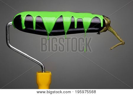 Paint Roller Eggplant With Pouring Toxic Green Paint On Gray Background. Fashion Food Concept.creati