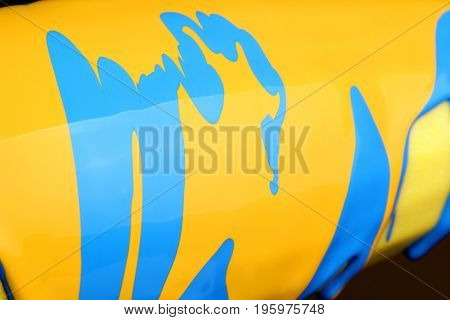 Pouring Blue Paint Over Yellow Background, Macro Closeup.texture.abstract