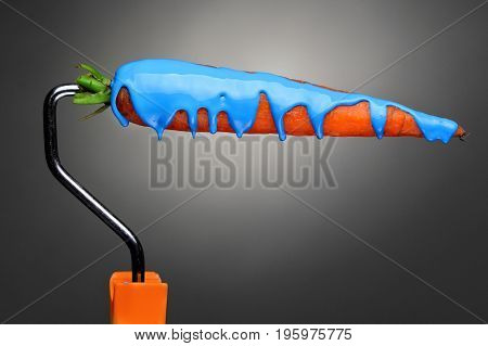 Paint Roller Carrot With Pouring Blue Paint On Gray Background. Fashion Food Concept.creative Advert