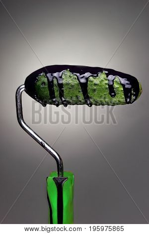Paint Roller Cucumber With Pouring Black Paint On Gray Background. Fashion Food Concept.creative Adv
