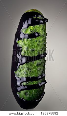 Cucumber With Pouring Blue Paint On Gray Background. Fashion Food Concept.creative.
