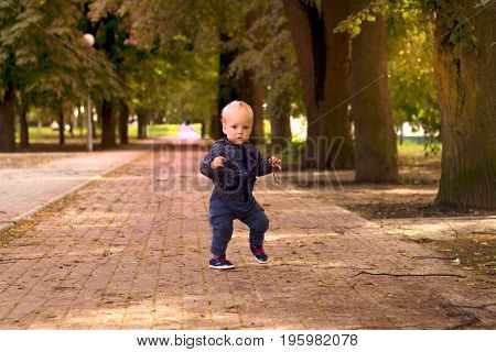 Funny toddler dancing in gangnam style. Outdoor shot.
