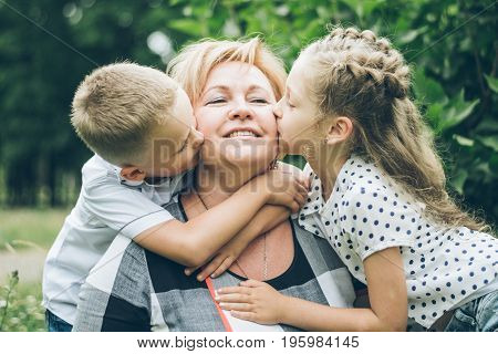 Grandmother with grandchildren hugging in the park