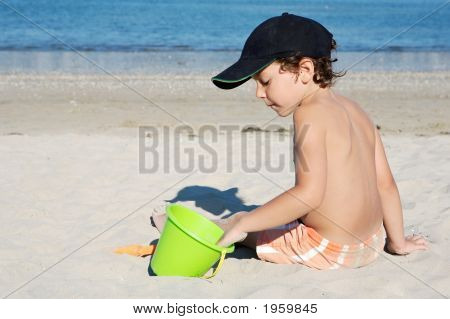 Boy Playing In The Beach