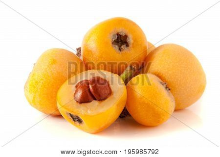 Ripe loquat or Eriobotrya japonica with leaf isolated on white background.