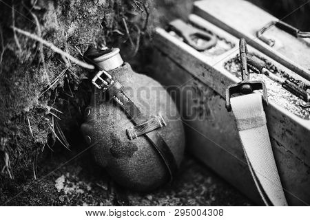 Old German Wehrmacht Times Of World War Ii Vintage Flask And Box Of Ammunition On Ground. Photo In B