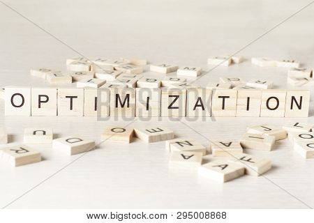 Optinization Word Written On Wood Block. Wooden Abc