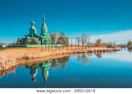 Old Wooden Russian Orthodox Church Near Lake In Early Spring Or Late Autumn Season. Sunny Day.
