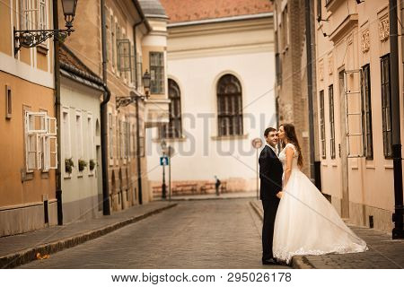 Bride And Groom Hugging In The Old Town Street. Weding Couple In Love. Weeding In Budapest.