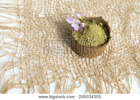 Henna Powder For Dyeing Hair And Eyebrows And Drawing Mehendi On Hands, Isolate With Green Palm Leaf
