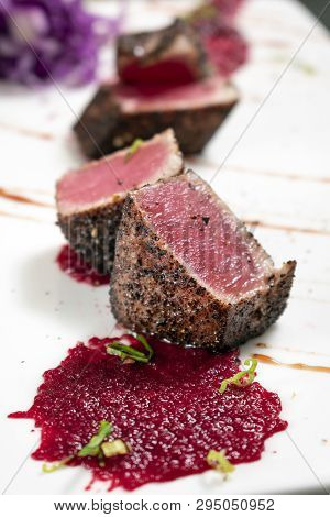 Gourmet Seared Tuna In Black Pepper Crust With Beetroot And Raspberry Coulis