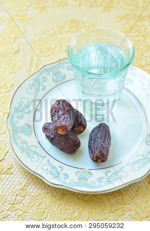 A glass of water and ripped dates - a food that is consumed while breaking fast during holy month of Ramadan