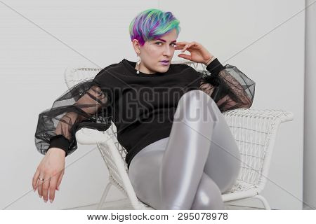 A Young Woman With Short Hair, A Pixie Bob Haircut, Different Colored Hair, Blue, Green, Violet.