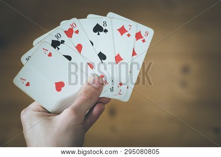 Playing Cards: Poker Cards In The Hand Of A Man