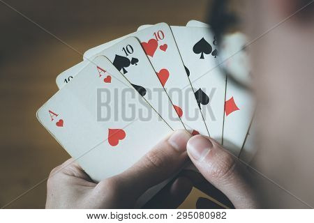 Playing Cards: Poker Cards In The Hand Of A Man