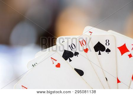 Playing Cards: Poker Cards In The Hand Of A Man