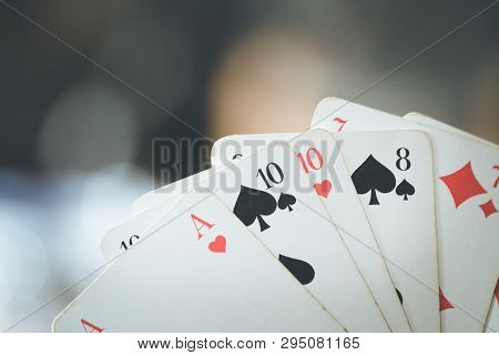 Playing Cards: Poker Cards In The Hand Of A Man