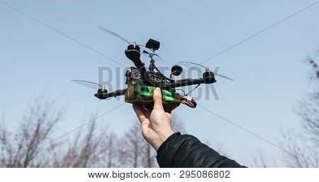 Pilot Racing Drone Holds In His Hand Fpv Copter Before Launching It. A Small High-speed Aircraft Wit