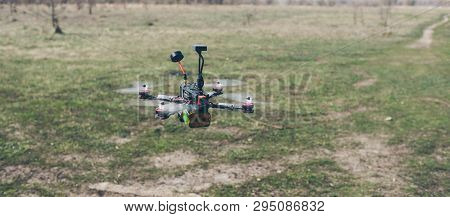 A Small Fpv Racing Drone Is Ready To Fly And Hovered Above The Ground Before The Race. Self-made Fly