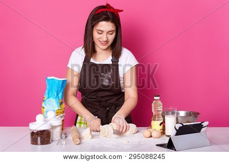 Woman Baker Cuts Dough In Small Parts, Ready For Sculpting Hot Cross Buns, Make Pies From Dough, Wea