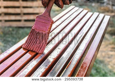 House Painter Paints Metal Structures. Protective Coating Of Steel Closed Profiles With Primer Iron 