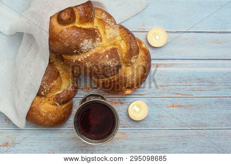 Shabbat Shalom - Challah Bread, Shabbat Wine And Candles On Blue Wooden Background. Top View, Copy S