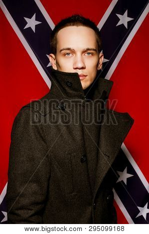 Fashionable Male Model Over Background Made Of American Flag. Grunge Style. Studio Shot