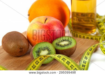 Apple, Orange, Kiwi With Measure Tape On White Background