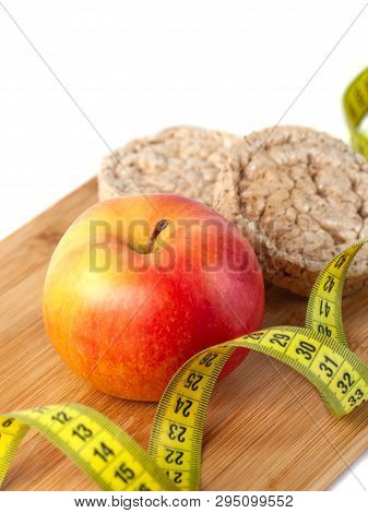 Apple, Orange, Kiwi With Measure Tape On White Background