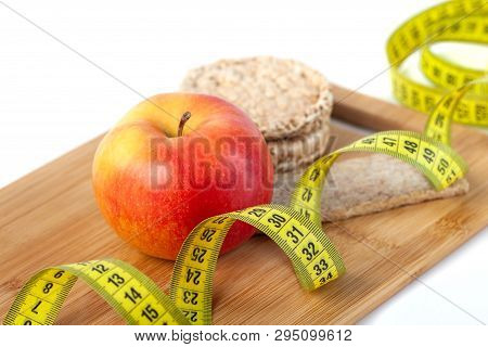 Apple, Orange, Kiwi With Measure Tape On White Background
