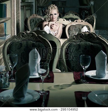 Young Beautiful Woman Waiting For Dinner In Restaurant