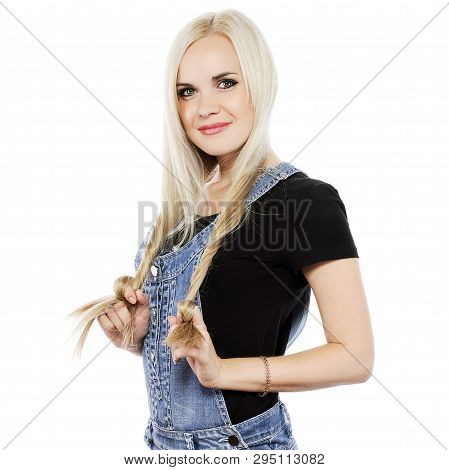 Portrait Of A Smiling Next Door Girl In Country Style Clothes Over White Background. Studio Shot